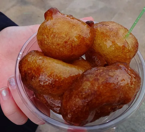 A cup of lokma syrup-soaked fried dough balls sold beside Galata Bridge, Istanbul.