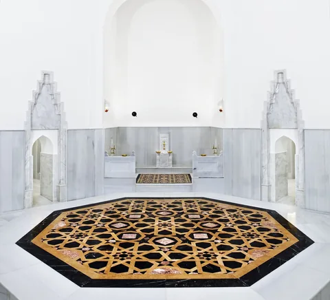 White-marble hot-room interior in the historic Hürrem Sultan Hamam after restoration.