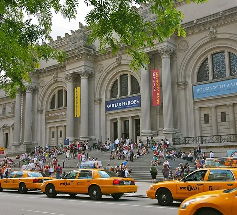 The Met Fifth Avenue façade, busy steps and yellow taxis, 2011.